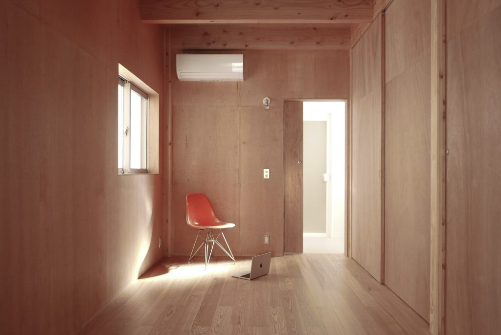 Study and bedroom area in O-Studio featuring calm materials and minimal furnishings.