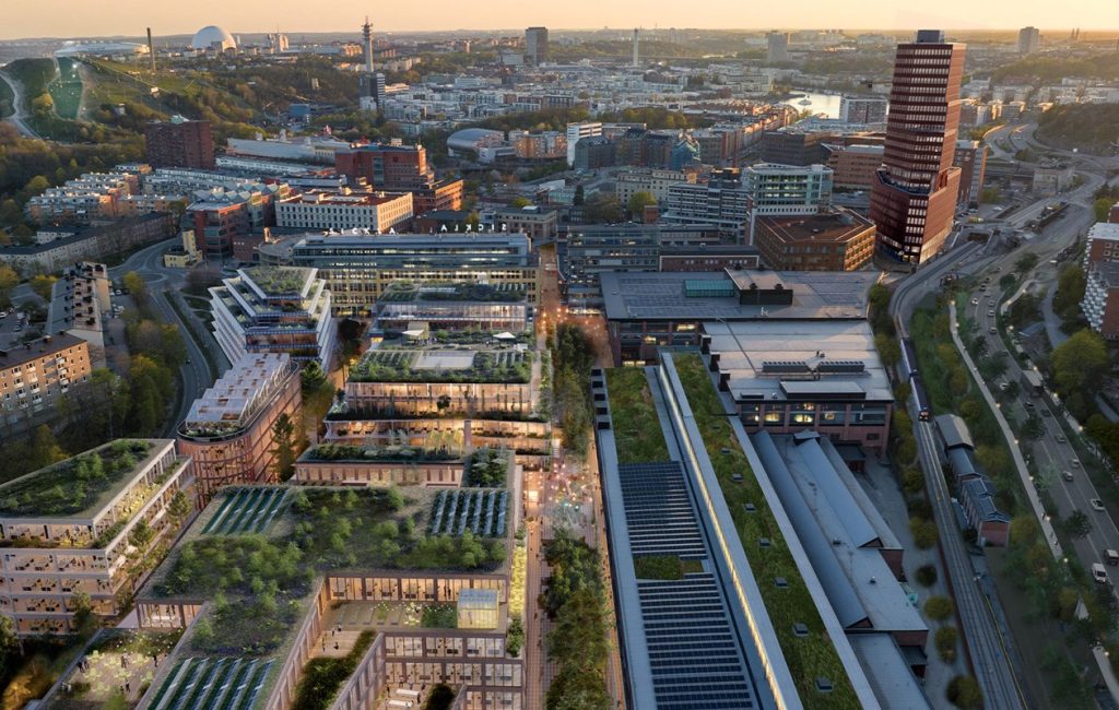 Aerial rendering of Stockholm Wood City showing timber buildings, green roofs and pedestrian friendly streets in the Sickla district.