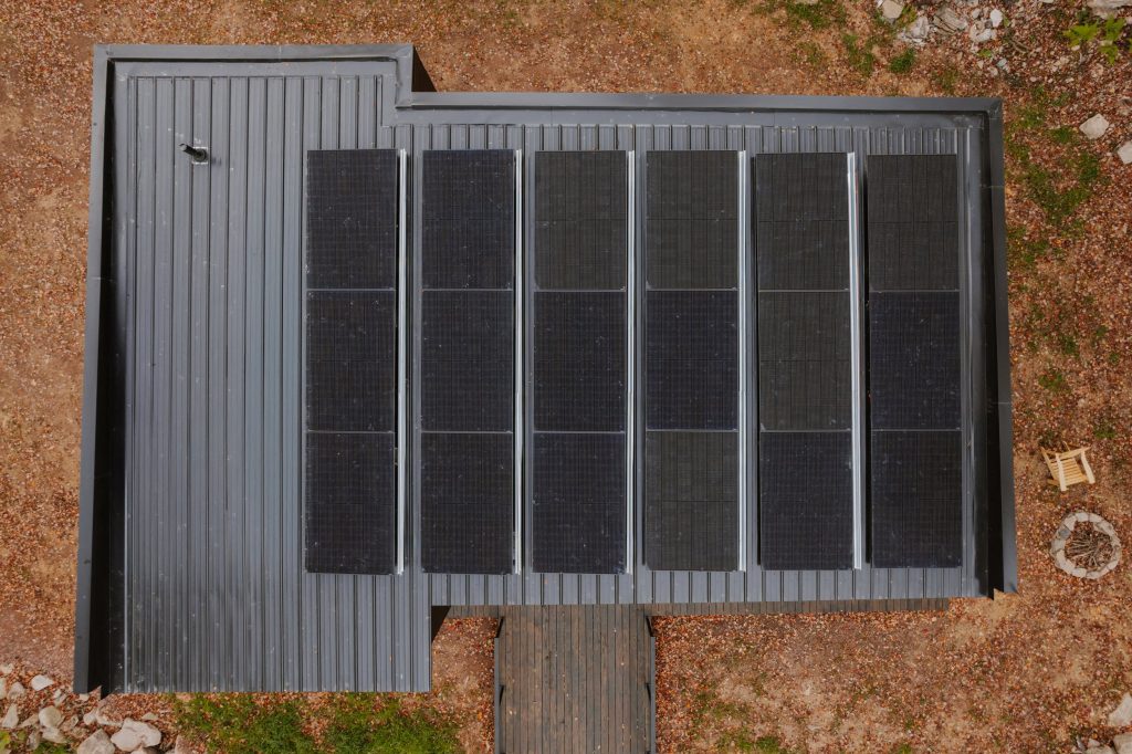 Top view of the house with rooftop solar panels visible.