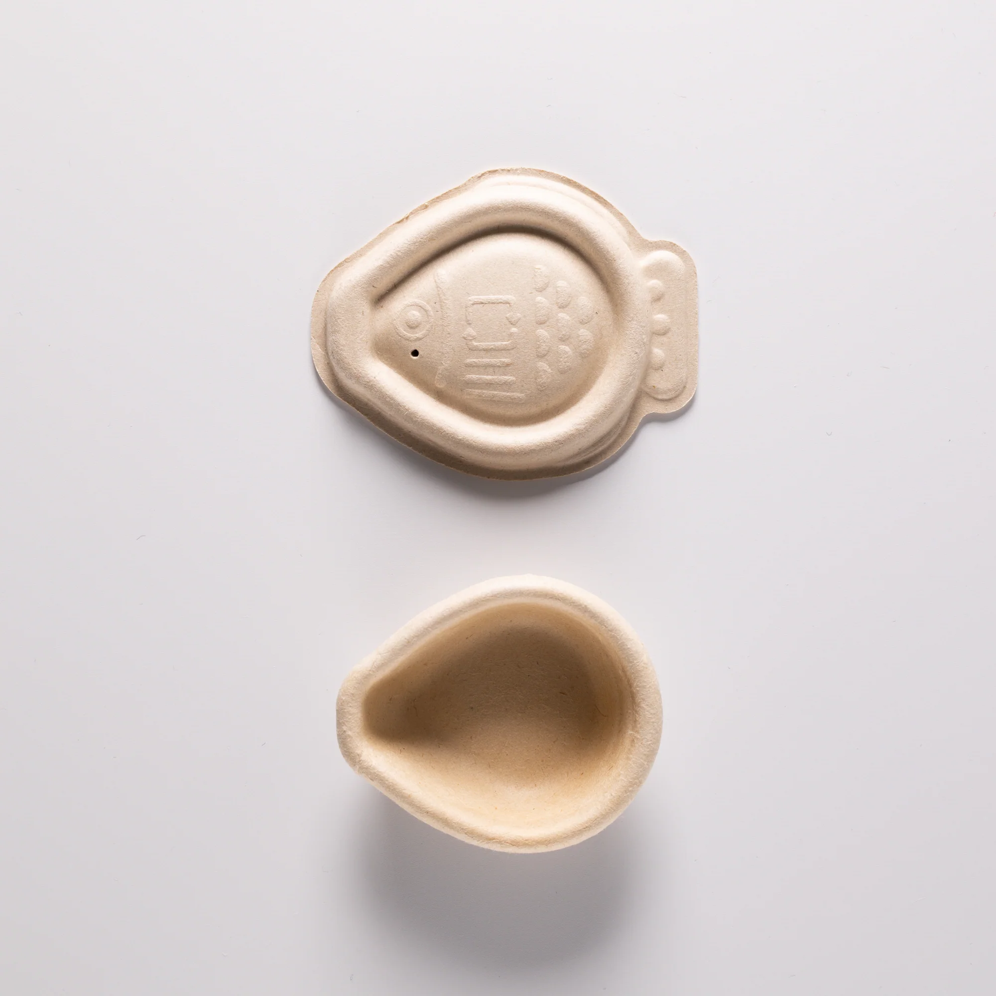 Compostable soy sauce fish designed to replace traditional single-use plastic containers